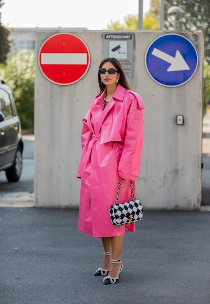MILAN, ITALY - SEPTEMBER 24: Bettina Looney seen wearing pink oversized coat, checkered black white ...