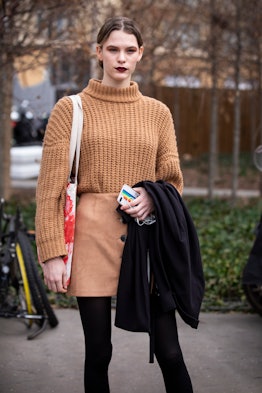 A model, wearing a beige sweater and beige mini skirt, is seen outside Chloe February 28, 2019 in Pa...