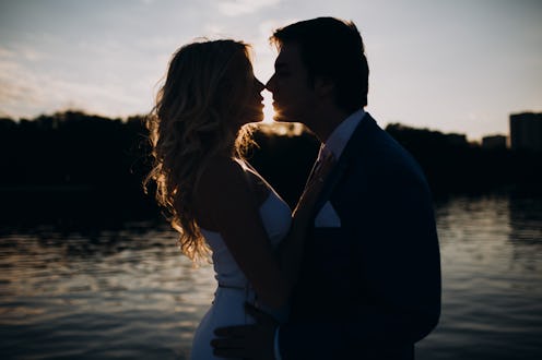 wedding couple posing by the water