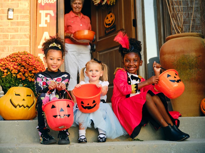 group of kids in Halloween costumes ready for trick-or-treating