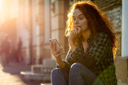 Surprised woman reading on phone