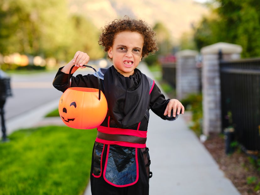 Children celebrating Halloween in a costume, before going trick or treating.