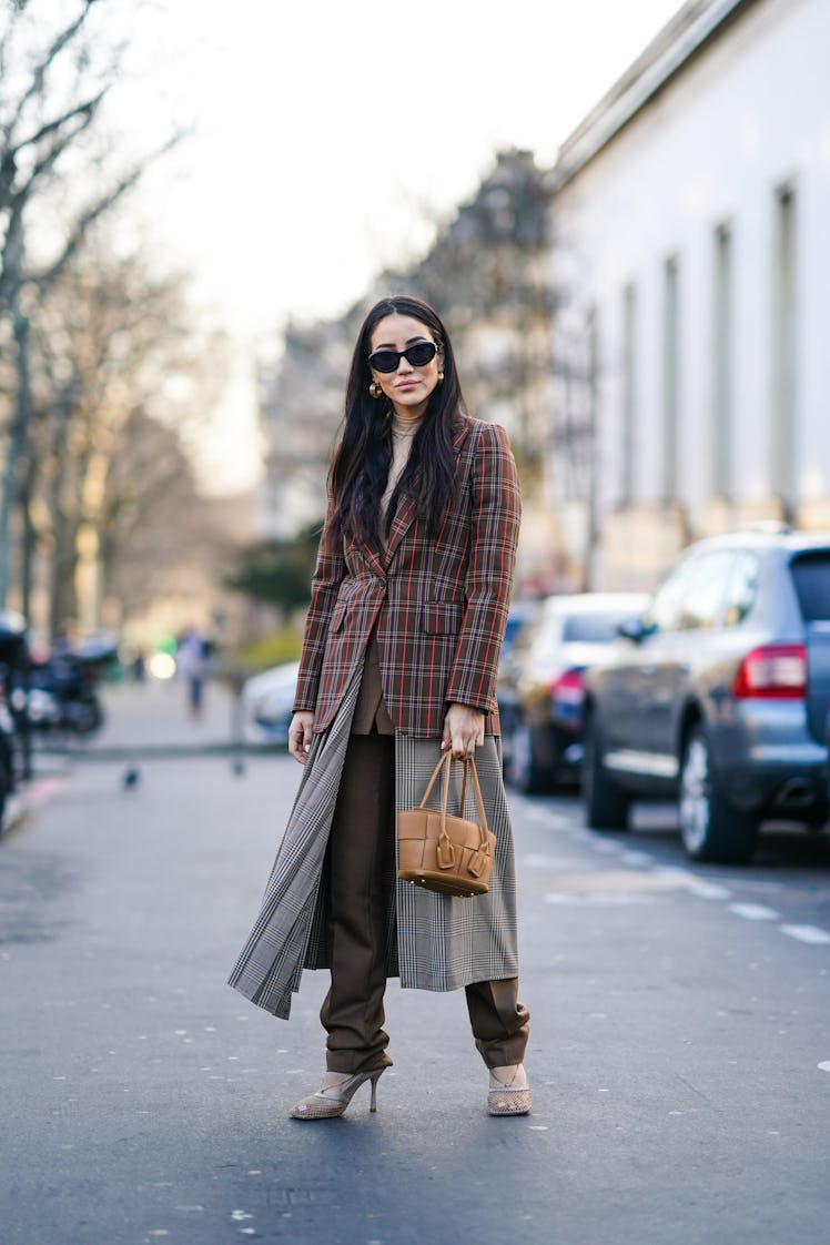PARIS, FRANCE - JANUARY 20: Tamara Kalinic wears sunglasses, earrings, a beige turtleneck, a colorfu...