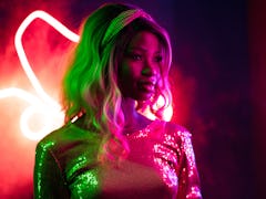 Young woman in studio, lit by neon light, during the October 2021 full moon in Aries, which will aff...