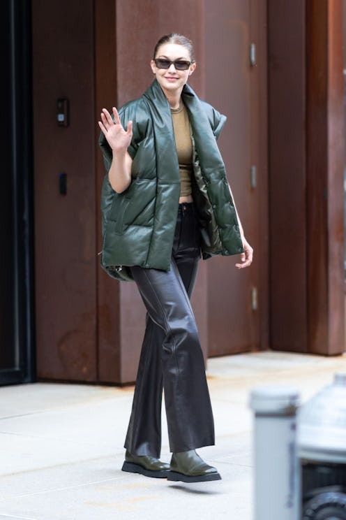 Gigi Hadid wears oversized leather puffer vest from FRAME and Wandler Rosa boots while out and about...