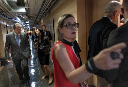 WASHINGTON, DC - JUNE 08: U.S. Sens. Kyrsten Sinema (D-AZ) (R) and Joe Manchin (D-WV) arrive for a ...