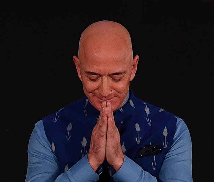 CEO of Amazon Jeff Bezos (R) greets during the Amazon's annual Smbhav event in New Delhi on January ...