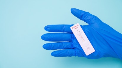 Doctor holding a test kit for viral disease COVID-19 2019-nCoV. Lab card kit test for viral novel co...