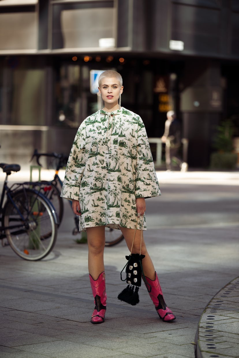 STOCKHOLM, SWEDEN - AUGUST 31: Cajsa Wessberg wearing Baum und Pferdgarten dress, pink cowboy boots,...