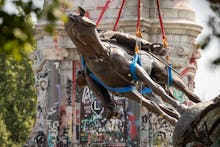 EDITORS NOTE: Graphic content / The statue of Confederate General Robert E. Lee is removed from Monu...