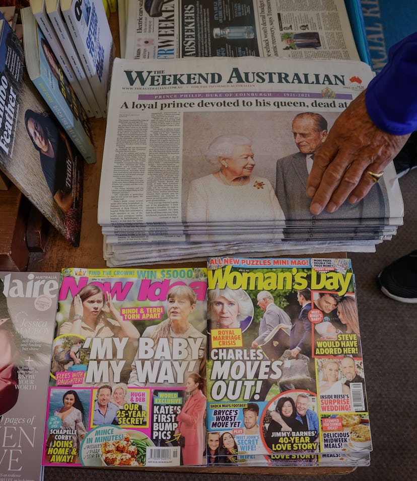 SYDNEY, AUSTRALIA - APRIL 10: A customer at a newsagent picks up an Australian newspaper reporting o...
