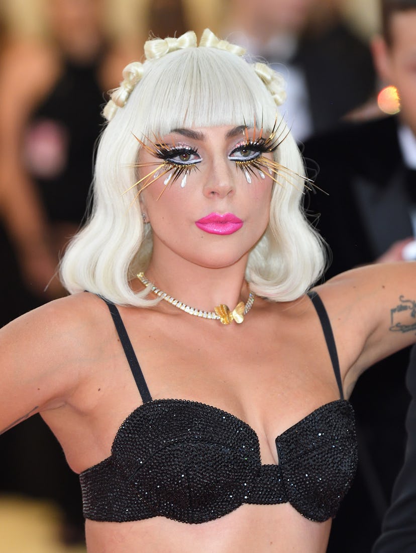 Lady Gaga’s Met Gala Camp makeup look featured false lashes and a bold pink lip.