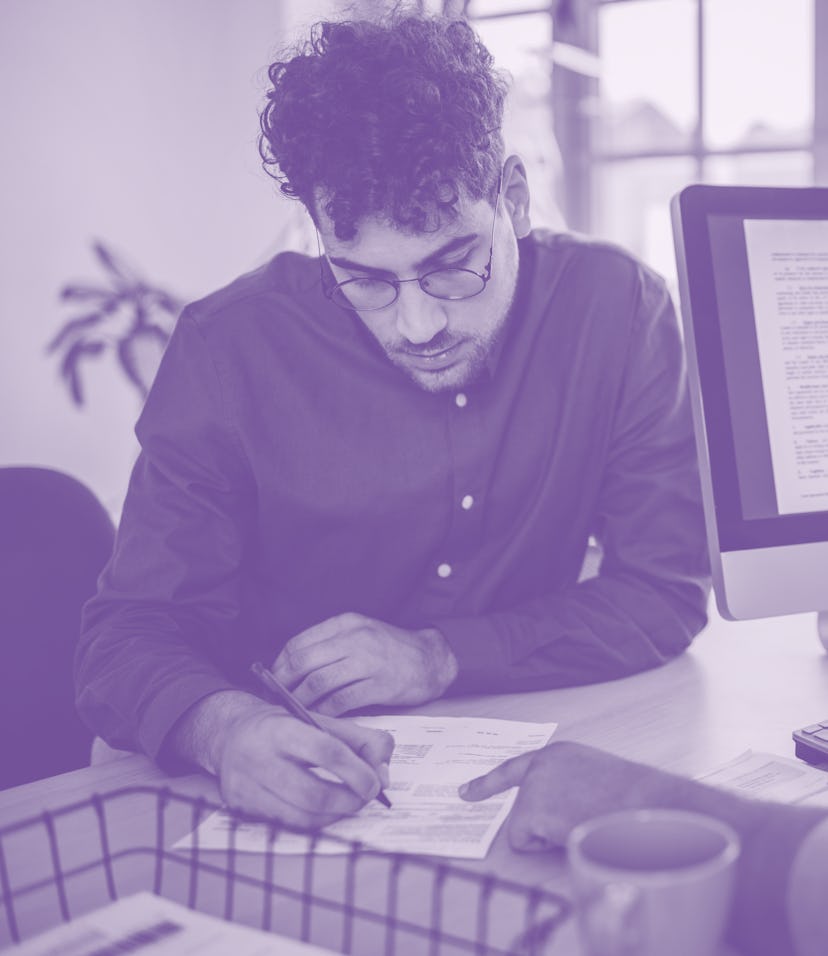 Two people, young man on a job interview in modern office. Male manager is interviewing him.