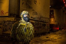 TOPSHOT - Federal police guard the Mark O. Hatfield federal courthouse in downtown Portland as prote...