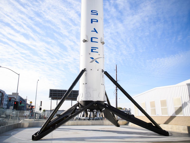 The recovered first stage of a Falcon 9 rocket stands at Space Exploration Technologies Corp. (Space...