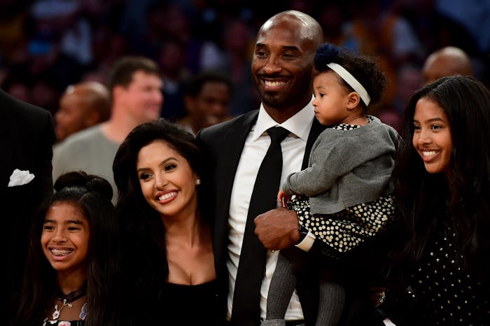 LOS ANGELES, CA - DECEMBER 18: Kobe Bryant poses with his family at halftime after both his #8 and ...