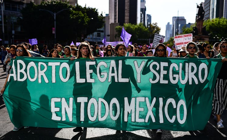 Women carry a banner reading "Legal and Safe Abortion Across Mexico" as they march during the commem...