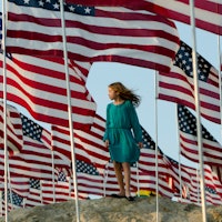 A girls stands amongst US national flags erected by students and staff from Pepperdine University to...