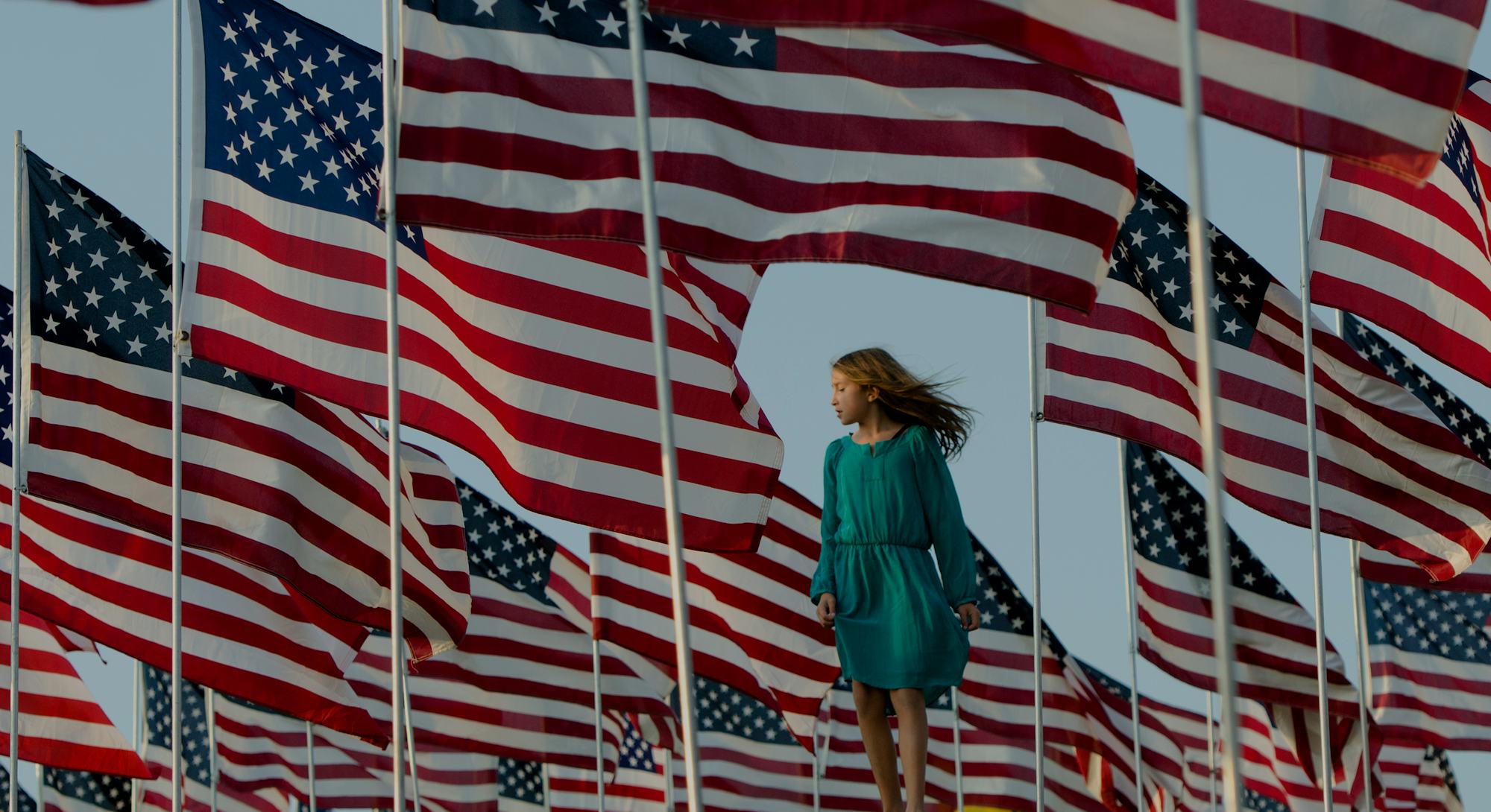 A girls stands amongst US national flags erected by students and staff from Pepperdine University to...