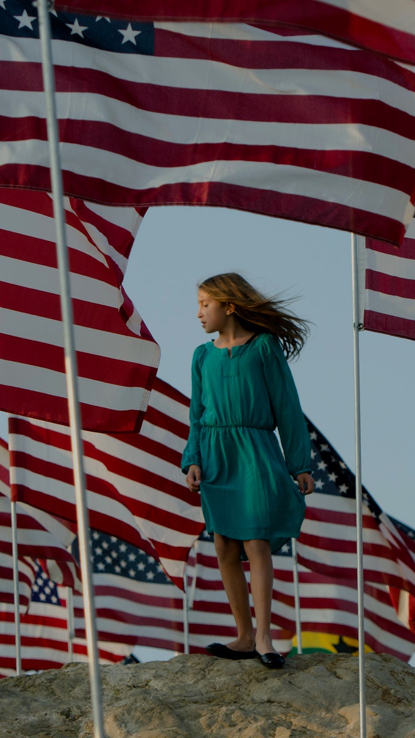 A girls stands amongst US national flags erected by students and staff from Pepperdine University to...