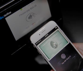 An Apple employee demonstrates Apple Pay on Tuesday, September 9,  2014 in Cupertino, Calif. (Photo ...