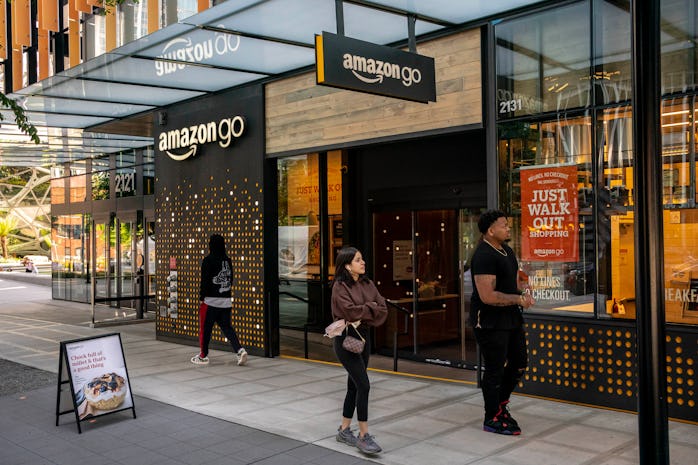 SEATTLE, WA - MAY 20: People walk by an Amazon Go store at the Amazon.com Inc. headquarters on May 2...