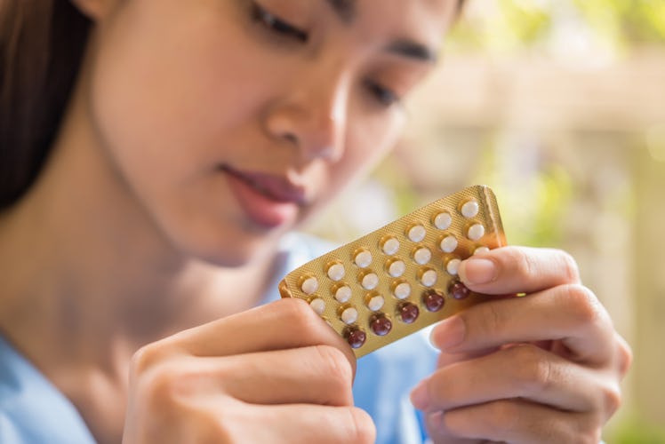 Woman hand holding a contraceptive panel prevent pregnancy