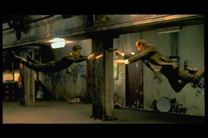 Keanu Reeves and Hugo Weaving face each other in a scene from Andy and Larry Wachowski's 1999 movie ...