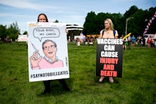 Two women hold anti-vaccination signs during a protest against Governor Jay Inslee's stay-at-home or...
