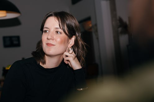 Friends of mixed genders and ages gather to celebrate a birthday and milestone anniversary. They ea...