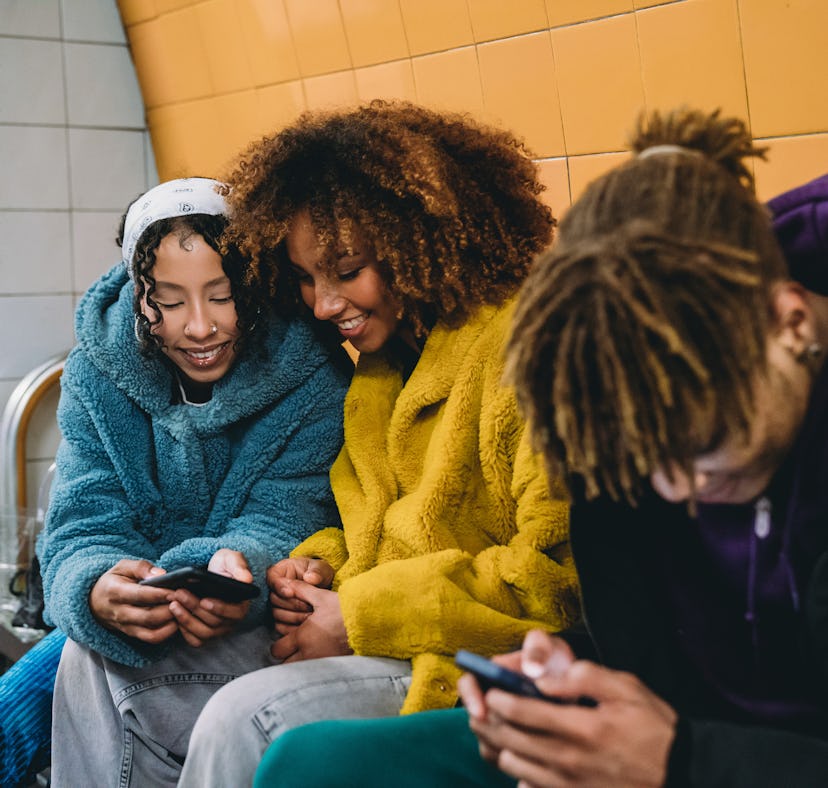 Three friends waiting for the train in a subway station and talking about something cheugy, test the...