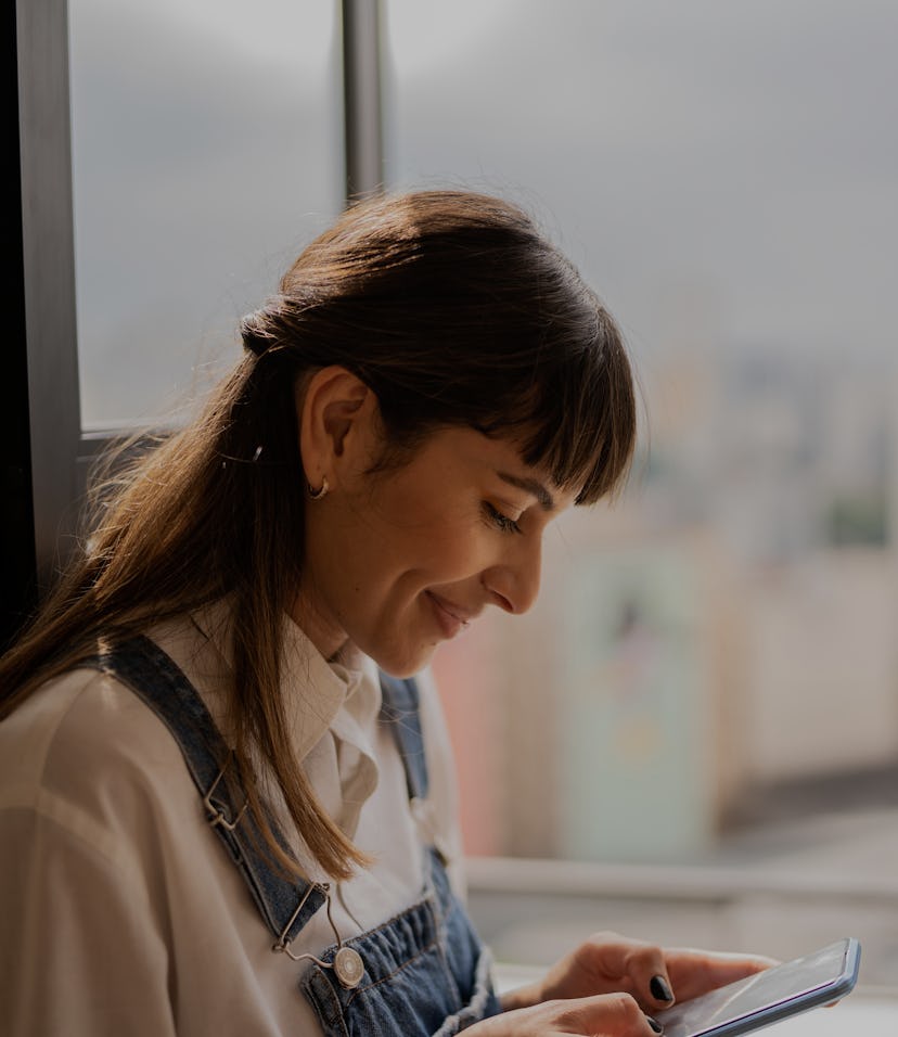 Young woman using the mobile phone at home