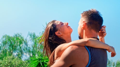 Couple hugging on sunny day outside