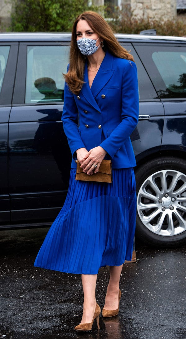 Britain's Catherine, Duchess of Cambridge, wears a protective face covering to combat the spread of ...