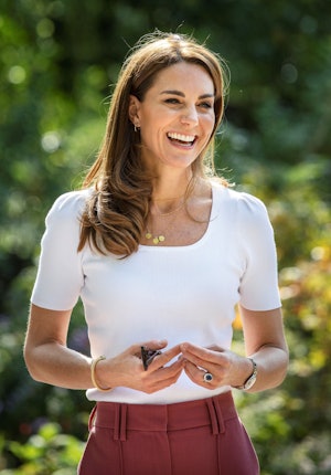Britain's Catherine, Duchess of Cambridge, reacts as she meets with parents and children, and peer s...