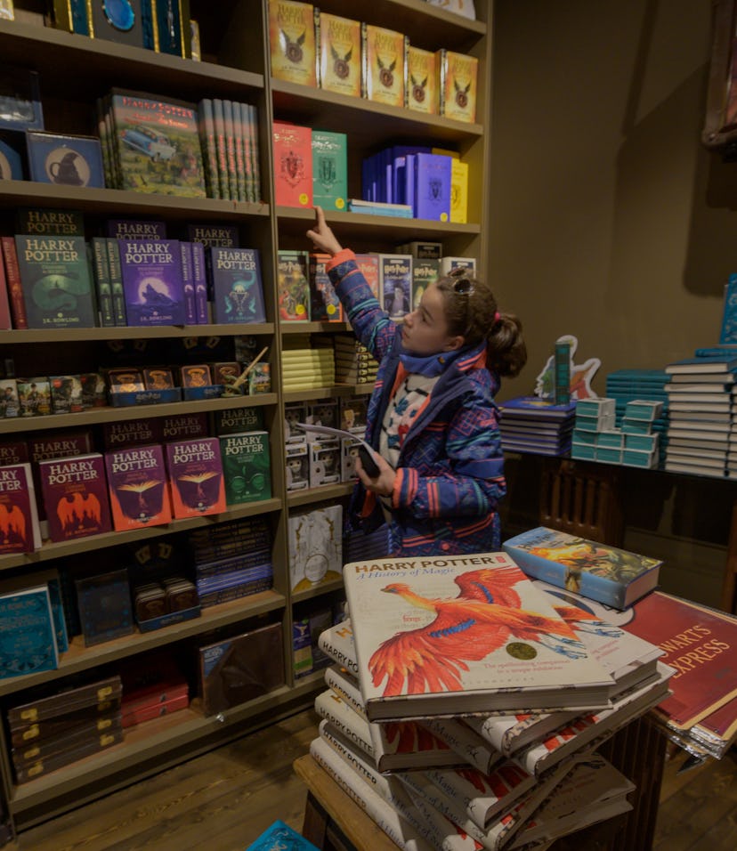 PORTO, PORTUGAL - JANUARY 12: A child chooses books at Harry Potter room in Lello Bookstore on the e...