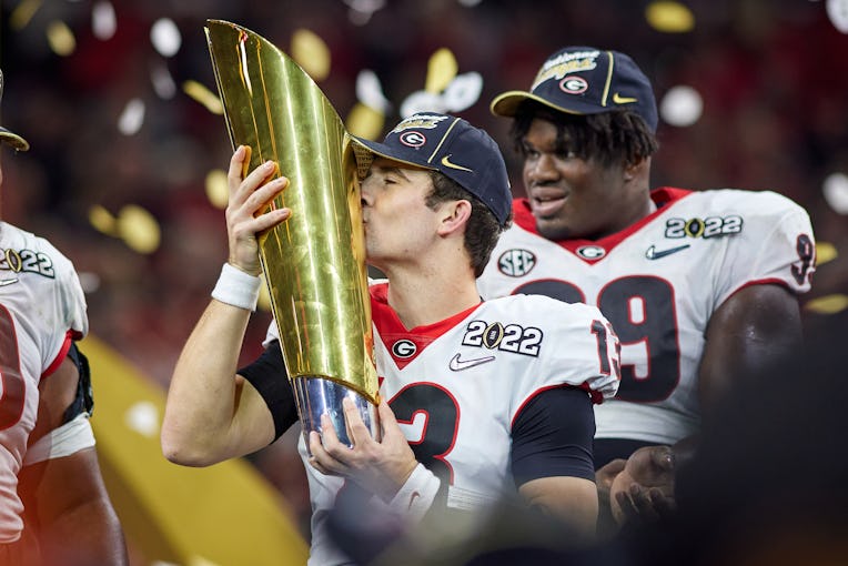 INDIANAPOLIS, IN - JANUARY 10: Georgia Bulldogs QB Stetson Bennett (13) celebrates and holds the nat...