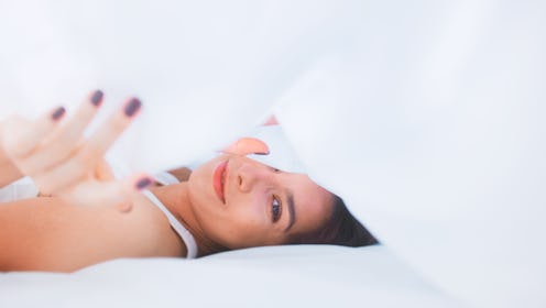 Young, beautiful woman dragging out in bed. Peaceful monring