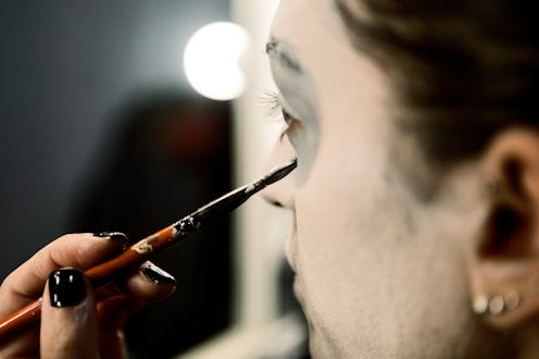 Woman painting face for Halloween night party
