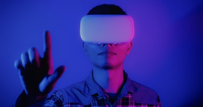 Digital composite of Man wearing VR Virtual Reality Headset with Interface, Future technology concep...