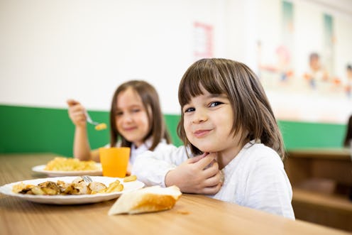 Back to school. Primary school children having school lunch at school cafeteria