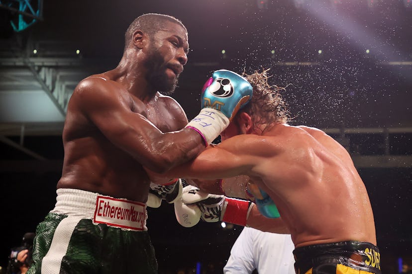 MIAMI GARDENS, FLORIDA - JUNE 06: Floyd Mayweather exchanges blows with Logan Paul (yellow shorts) d...