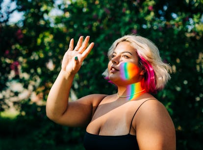 Young woman illuminated by a rainbow, thinking about her January 17, 2022 weekly horoscope.