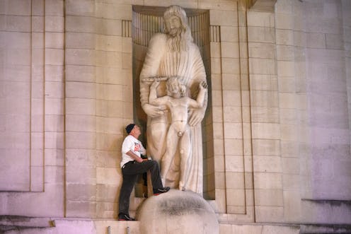 A protester holds a mallet while attempting to damage a statue by sculptor Eric Gill on BBC Broadcas...