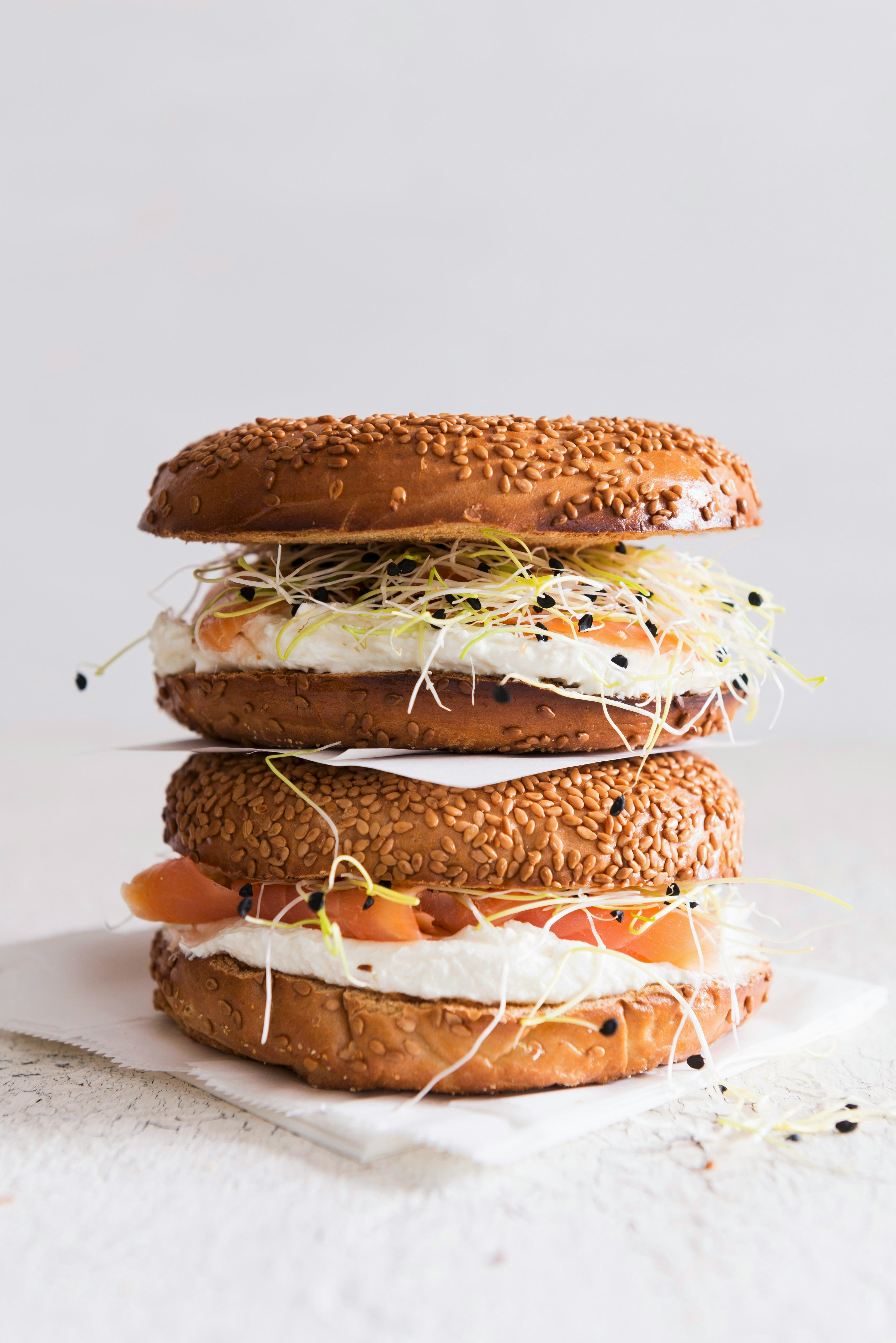 Sesame seed bagels with salmon, bean sprouts and cream cheese