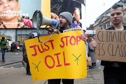 LONDON, UNITED KINGDOM - 2021/12/11: A protestor seen holding a placard that says 'just stop oil' wh...