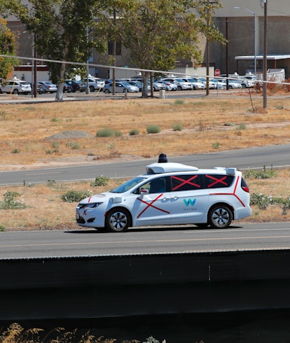 A Googgle Waymo autonomous vehicle navigates the roads inside their facility on the property of the ...