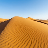 Oman, Wahiba Sands. the sand dunes at sunset