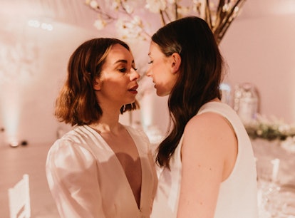 two women prepare to kiss on their wedding day, which they should avoid because it's the worst day t...