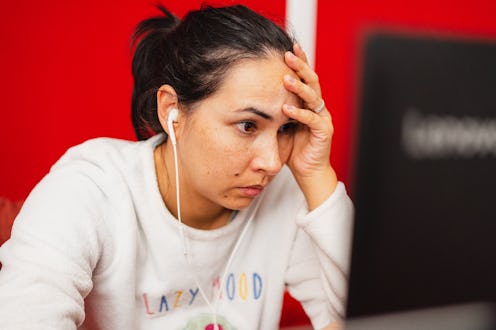 Woman looking stressed out at her computer